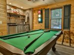 Game room with pool table and wet bar